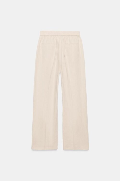 Pantalon en lin beige femme vue de dos, taille élastiquée et poches plaquées, coupe droite légère