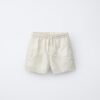 Short fille en coton bio blanc pur avec taille élastique et poches avant, produit durable pour enfant
