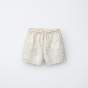 Short fille en coton bio blanc pur avec taille élastique et poches avant, produit durable pour enfant