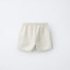 Short fille en coton bio blanc dos, taille enfant, ceinture élastiquée, coupe décontractée