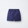 Short garçon en coton bio bleu uni, taille enfant, ceinture élastiquée visible, produit écologique