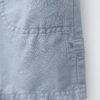 Short garçon en laine gris clair, détail poche et couture visible, étiquette côté